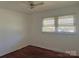 Bright bedroom with hardwood floors and natural light through large windows with blinds at 2210 Milton Rd, Charlotte, NC 28215