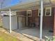 View of the carport that attaches to the house and features a concrete pad and a small storage shed at 2210 Milton Rd, Charlotte, NC 28215