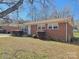 Quaint brick home with a well-manicured lawn and simple landscaping at 2210 Milton Rd, Charlotte, NC 28215