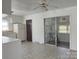 Eat-in kitchen with classic white cabinetry, tile flooring, and sliding door at 2210 Milton Rd, Charlotte, NC 28215