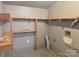 Unfinished laundry room with painted walls, utility connections, and built in wooden shelving at 2210 Milton Rd, Charlotte, NC 28215