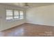 Bright living room featuring tile flooring, ceiling fan and large window at 2210 Milton Rd, Charlotte, NC 28215