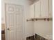 Functional mud room with white cabinets and storage, enhancing organization and convenience at 2210 Milton Rd, Charlotte, NC 28215