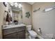 Charming half-bathroom with granite countertop, decorative fish accents and wood look tile floor at 2375 Ellison Cir, Lancaster, SC 29720