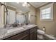 Bathroom featuring a double sink granite countertop, dark cabinets, and neutral color scheme at 2375 Ellison Cir, Lancaster, SC 29720