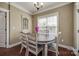 Bright breakfast nook features a wood table, stylish chairs, and natural light from a window at 2375 Ellison Cir, Lancaster, SC 29720