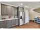 Stylish kitchen features stainless steel refrigerator, gray cabinets, and mosaic backsplash at 2375 Ellison Cir, Lancaster, SC 29720