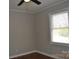 This bedroom features hardwood floors, fresh paint and a bright window at 2400 Pressley Rd, Chester, SC 29712