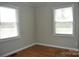 A clean bedroom with two windows and hardwood floors at 2400 Pressley Rd, Chester, SC 29712