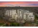 Beautiful high-rise condo complex with balconies and city views at sunset at 2823 Providence Rd # 156, Charlotte, NC 28211