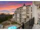 Luxury high-rise exterior showing meticulous landscaping, an outdoor pool, and a dramatic sky at 2823 Providence Rd # 156, Charlotte, NC 28211