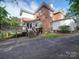 Back exterior view featuring the deck, brickwork, and access to the backyard at 303 Wade St, Wadesboro, NC 28170