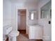 Bathroom featuring a toilet, vanity with sink, and neutral paint, providing a functional space at 303 Wade St, Wadesboro, NC 28170