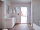 Bathroom with a sink, mirror, neutral paint, and a doorway to another room at 303 Wade St, Wadesboro, NC 28170