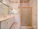 A bathroom featuring a tub with gold trim and a vanity with a large mirror at 303 Wade St, Wadesboro, NC 28170