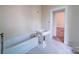 Bathroom with a clawfoot tub, pedestal sink, and neutral walls, offering a vintage feel at 303 Wade St, Wadesboro, NC 28170