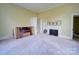 Bedroom featuring carpeted floors, a fireplace with mantel, and neutral-toned walls, creating a cozy space at 303 Wade St, Wadesboro, NC 28170