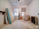 Bedroom with vintage furniture, radiator, and window with striped curtains at 303 Wade St, Wadesboro, NC 28170