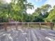 Spacious wooden deck overlooking a private, tree-lined backyard at 303 Wade St, Wadesboro, NC 28170