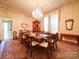 Spacious dining room features a large window, chandelier and dark wood furniture at 303 Wade St, Wadesboro, NC 28170