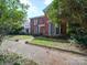 Brick two-story home with symmetrical design and welcoming front yard at 303 Wade St, Wadesboro, NC 28170