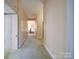 Hallway with multiple doors, neutral paint, and carpet, offering a glimpse into the home's layout at 303 Wade St, Wadesboro, NC 28170