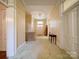 Long hallway with carpet, radiator, lighting fixture and doorways at end at 303 Wade St, Wadesboro, NC 28170