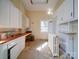 Kitchen with white cabinets, wood countertops, and natural light at 303 Wade St, Wadesboro, NC 28170