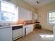 Bright kitchen with white cabinetry and wood countertops at 303 Wade St, Wadesboro, NC 28170