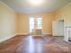 Bright living room featuring hardwood floors, a fireplace, and two windows at 303 Wade St, Wadesboro, NC 28170