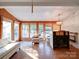 Living room with wood paneling, parquet floors, and ample windows at 303 Wade St, Wadesboro, NC 28170