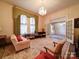 Living room with a floral rug, chandelier, curtains, and neutral walls at 303 Wade St, Wadesboro, NC 28170