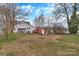 Large backyard featuring a shed and some mature trees and grass at 315 E Washington Ave, Bessemer City, NC 28016