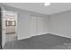 Spacious bedroom featuring a closet and gray vinyl flooring with a bathroom off to the left at 315 E Washington Ave, Bessemer City, NC 28016