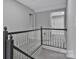 Second floor hallway with gray trim and access to bedrooms and bathrooms at 315 E Washington Ave, Bessemer City, NC 28016