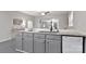 Kitchen island with granite countertop, sink, and gray cabinets at 315 E Washington Ave, Bessemer City, NC 28016