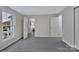 View of a bright living room with windows and gray vinyl flooring leading to other rooms at 315 E Washington Ave, Bessemer City, NC 28016