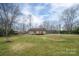 Expansive backyard featuring a wooden deck, light green siding, and a chain link fence at 3155 Ramseur St, Lincolnton, NC 28092