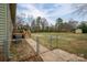 Fenced backyard featuring a large grassy area and wooden shed at 3155 Ramseur St, Lincolnton, NC 28092