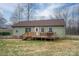 View of the house's backyard with a wooden deck and light green siding at 3155 Ramseur St, Lincolnton, NC 28092