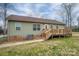 View of the house's backyard with a wooden deck and light green siding at 3155 Ramseur St, Lincolnton, NC 28092