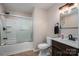 Cozy bathroom with combined shower and bathtub with sliding glass door, and a dark wood vanity at 3155 Ramseur St, Lincolnton, NC 28092