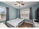 Cozy bedroom with natural light, featuring wood floors and large windows with curtains at 3155 Ramseur St, Lincolnton, NC 28092