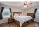 Bright bedroom featuring a cozy bed, wood-look floors, a ceiling fan, and natural light from the window at 3155 Ramseur St, Lincolnton, NC 28092