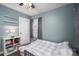 Blue walled bedroom featuring hardwood flooring, a ceiling fan, and plenty of natural light at 3155 Ramseur St, Lincolnton, NC 28092