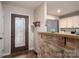 Inviting entryway featuring decorative front door, unique stone accents, and seamless transition into the kitchen and living area at 3155 Ramseur St, Lincolnton, NC 28092