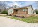 Charming home featuring light green siding, brick foundation, and a cozy front porch with wood railings at 3155 Ramseur St, Lincolnton, NC 28092