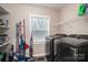 Functional laundry room with modern washer and dryer, storage shelves, and a bright window at 3155 Ramseur St, Lincolnton, NC 28092