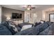 Well-lit living space featuring a spacious sectional sofa, ceiling fan, hardwood flooring and an open floor plan at 3155 Ramseur St, Lincolnton, NC 28092