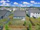 Aerial view of a fenced backyard featuring a well-manicured lawn, patio, and adjacent houses at 325 Ox Bow Cir, Mount Holly, NC 28120